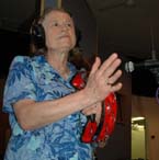 Photo of Kathy Schick playing tambourine.