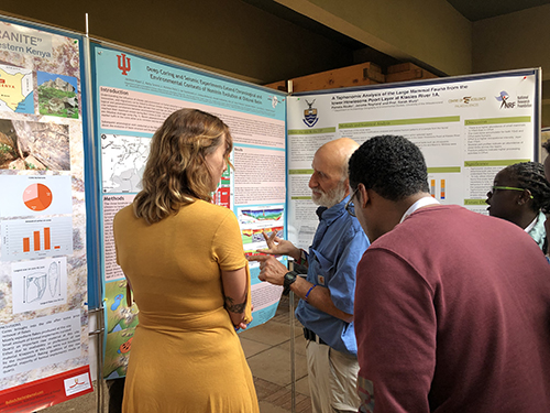 Danielle Peltier speaking with interested researchers during the poster presentation