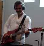 Photo of Sage Benato playing guitar.