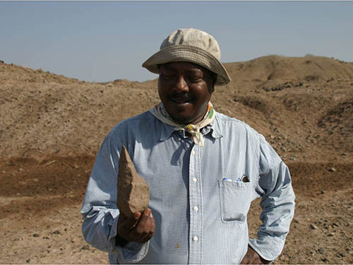 Researcher Sileshi Semaw with an Acheulean handaxe
